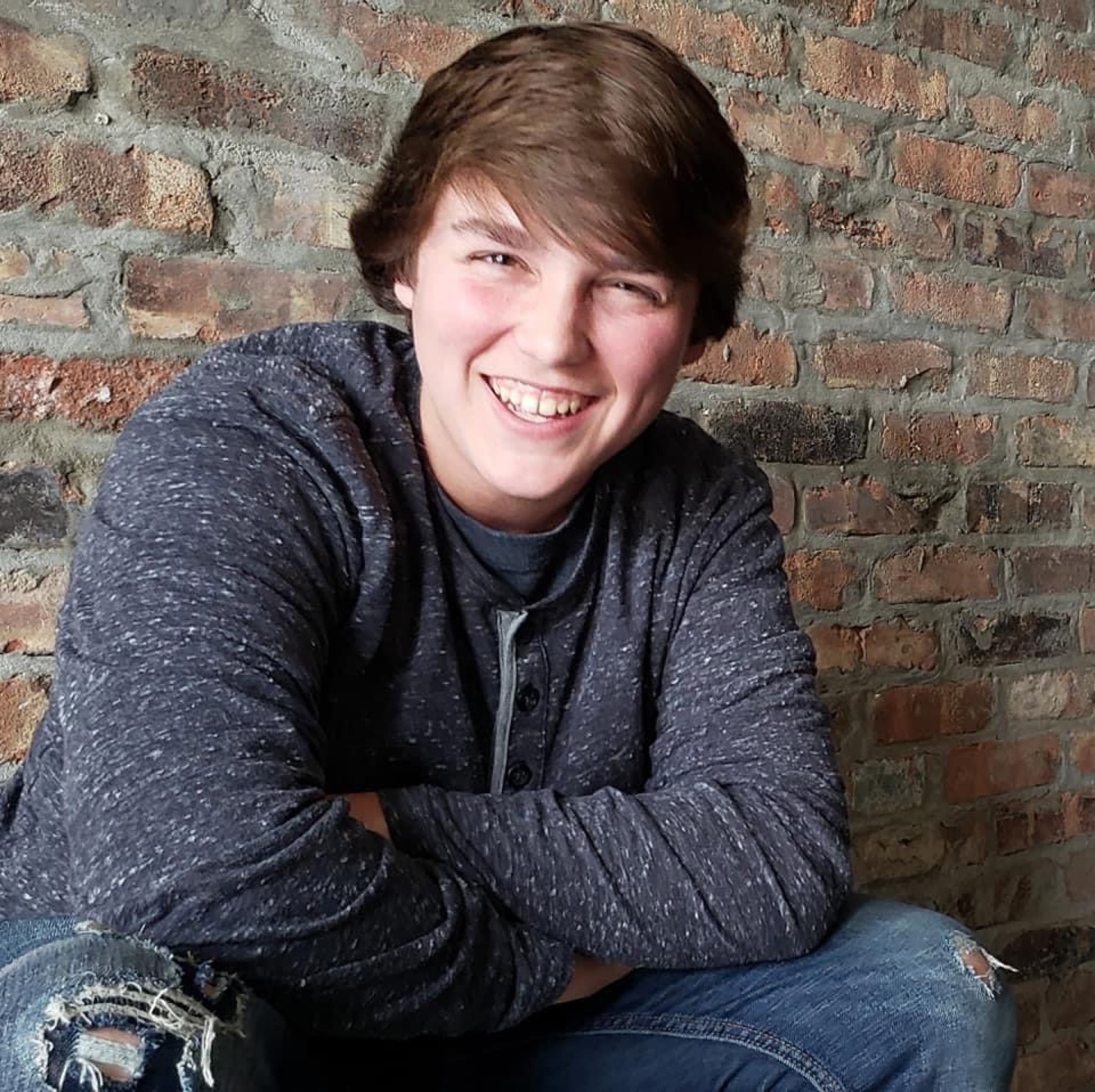 A joyful portrait against a brick wall