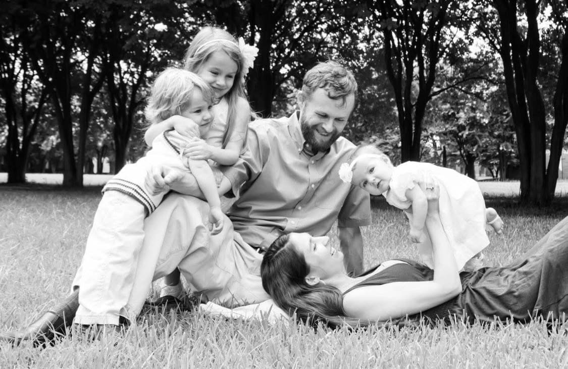 A family sharing a playful moment together outdoors