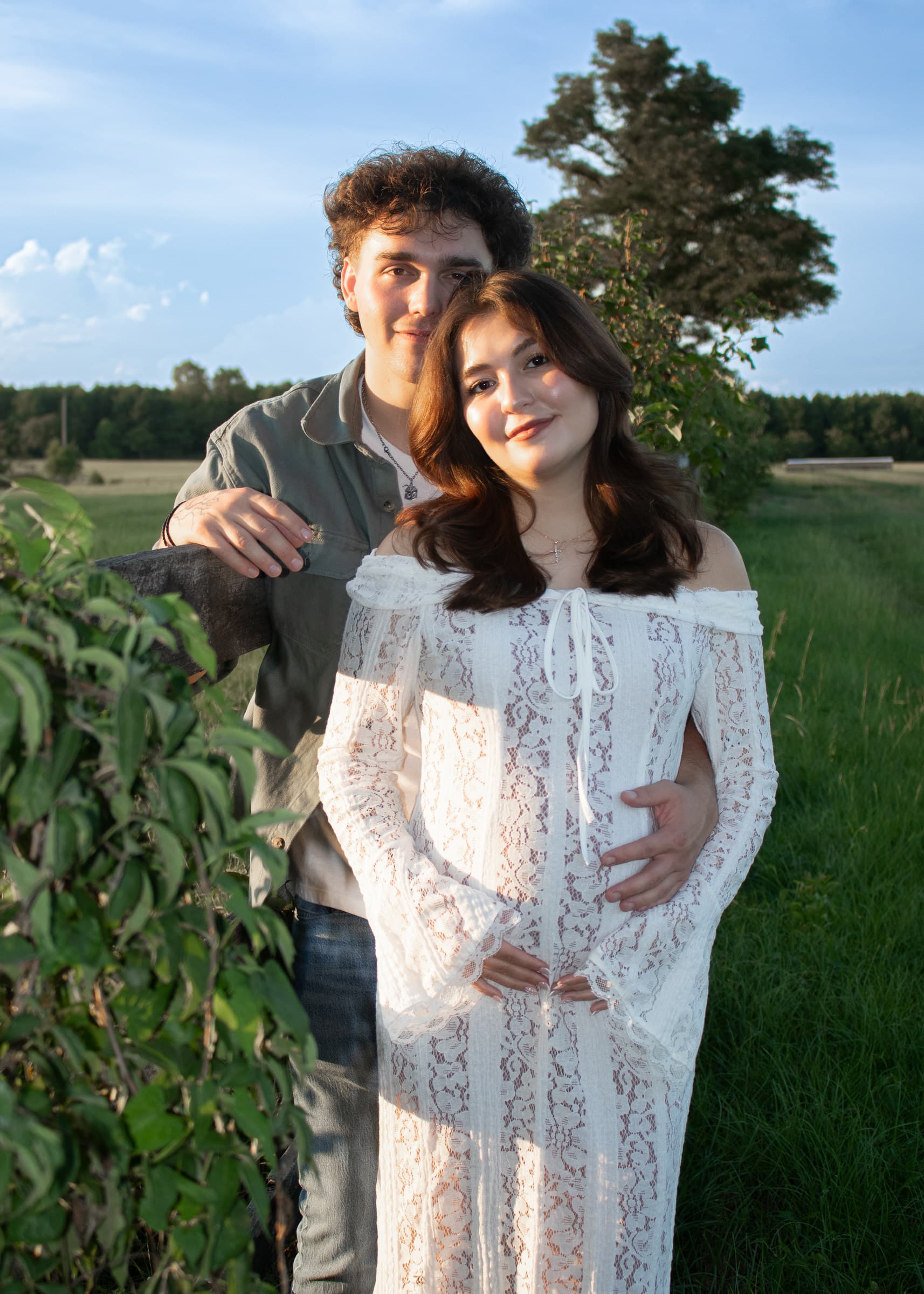 Close maternity portrait with hands resting on an expecting mother